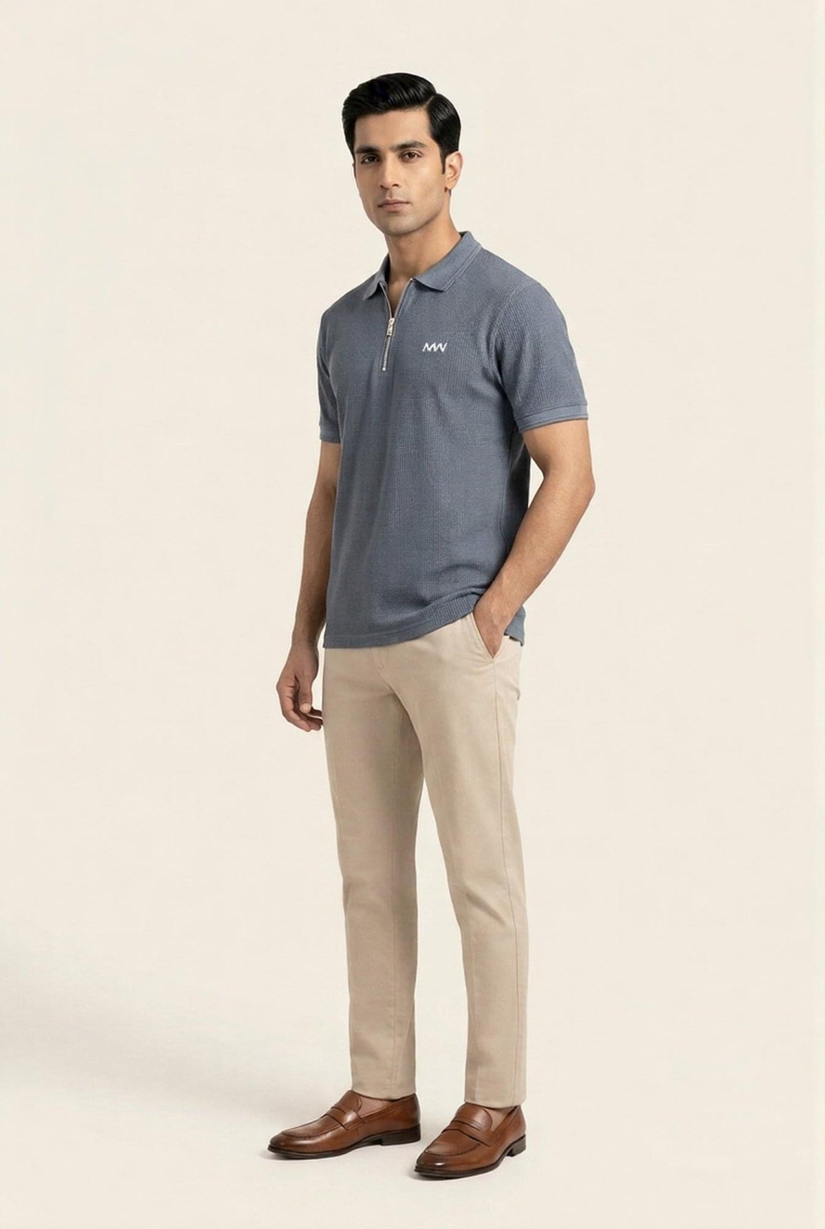 Man wearing gray textured polo shirt with zipper, beige chinos, and brown loafers — modern men's fashion