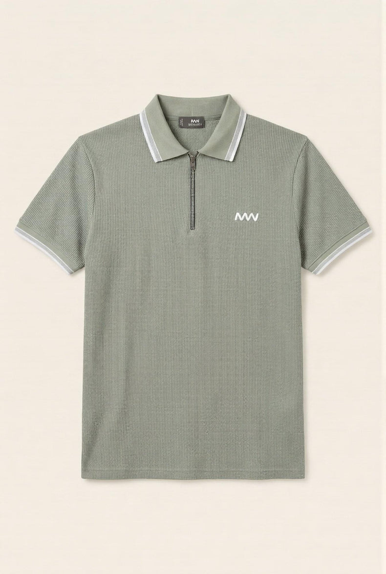 Olive green men's polo shirt with white trim and half-zip, featuring textured fabric and chest logo