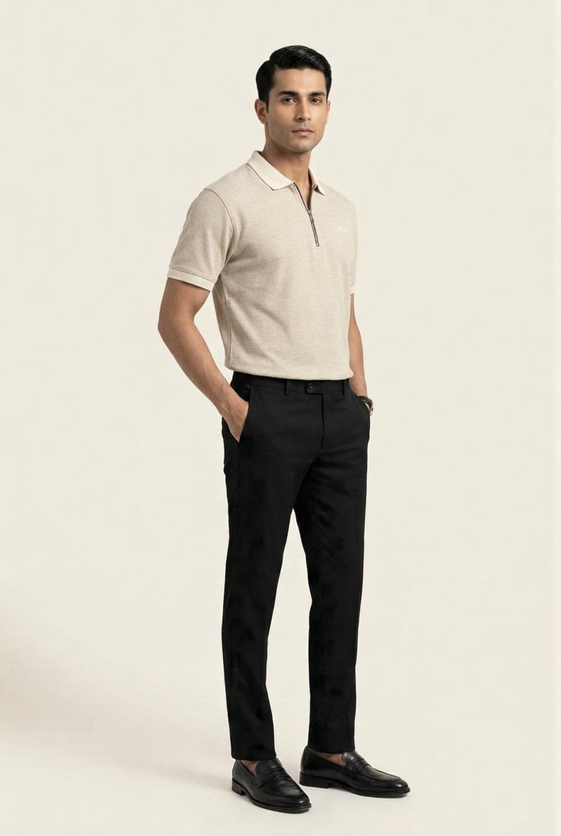 Man in beige half-zip polo shirt with black trousers and loafers, modern men's fashion