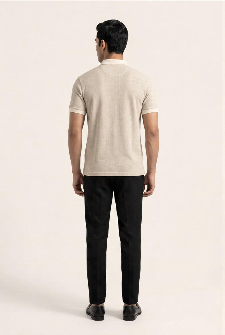 Man wearing beige polo shirt and black trousers, back view — premium men's clothing style