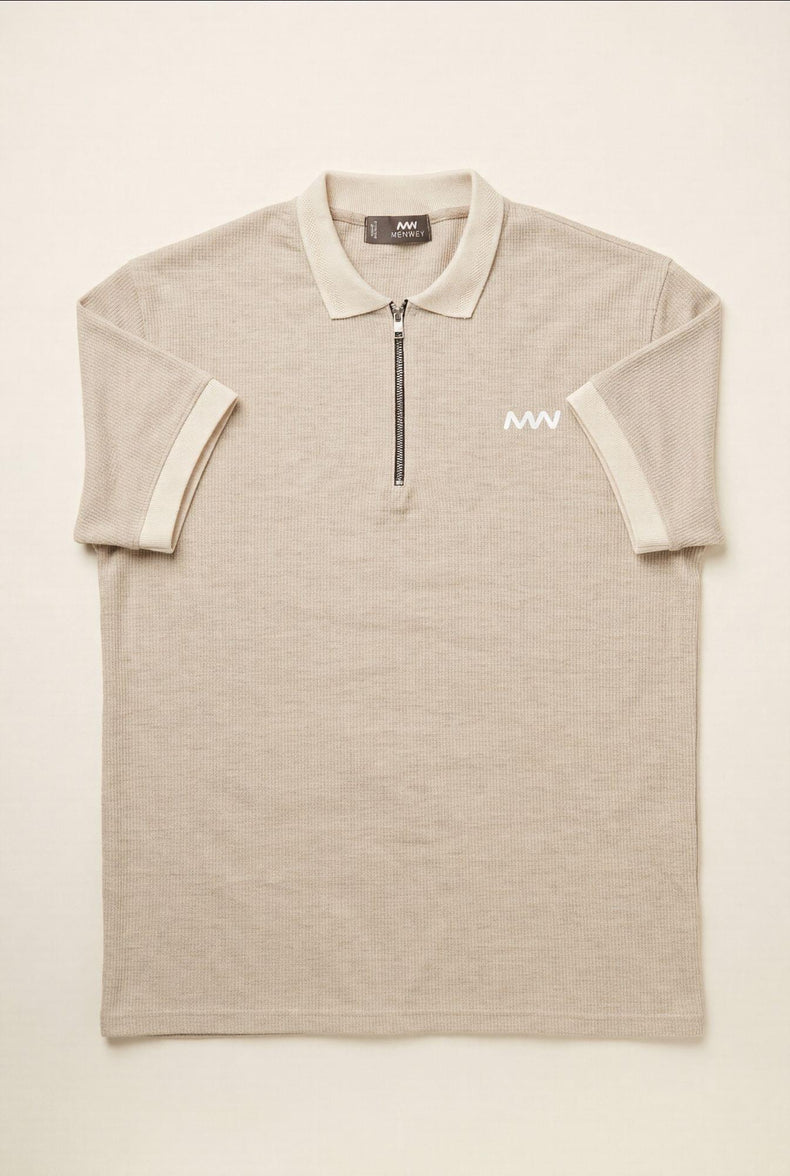 Beige men's polo shirt with half-zip, ribbed texture, and white logo — premium menswear style