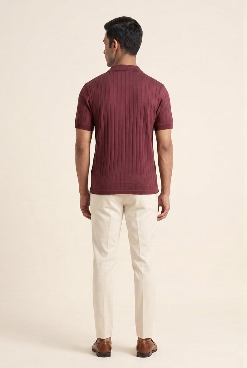 Man wearing burgundy ribbed polo shirt with cream trousers, back view — modern men's fashion