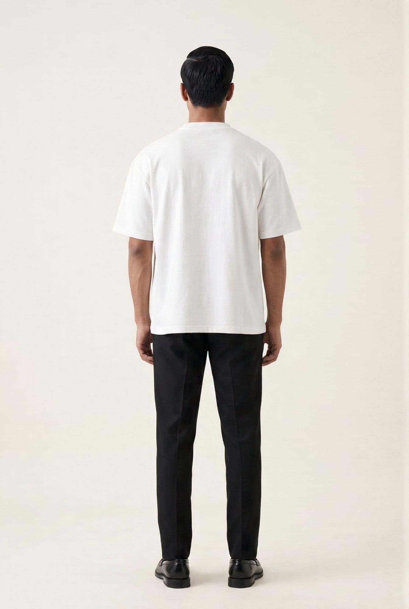 Man wearing white crew neck t-shirt and black tailored trousers, back view