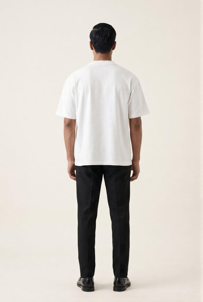 Man wearing white crew neck t-shirt and black tailored trousers, back view